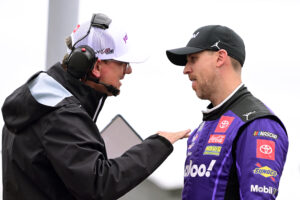 MADISON, ILLINOIS - JUNE 01: Denny Hamlin, driver of the #11 Yahoo! Toyota, and crew chief Christopher Gabehart talk on the grid during qualifying for the NASCAR Cup Series Enjoy Illinois 300 at WWT Raceway on June 01, 2024 in Madison, Illinois. (Photo by Logan Riely/Getty Images)