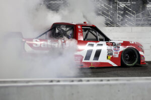 MARTINSVILLE, VIRGINIA - OCTOBER 24: Corey Heim, driver of the #11 Safelite Toyota, celebrates with a burnout after winning the NASCAR Craftsman Truck Slim Jim 200 at Martinsville Speedway on October 24, 2025 in Martinsville, Virginia. (Photo by Jared C. Tilton/Getty Images)