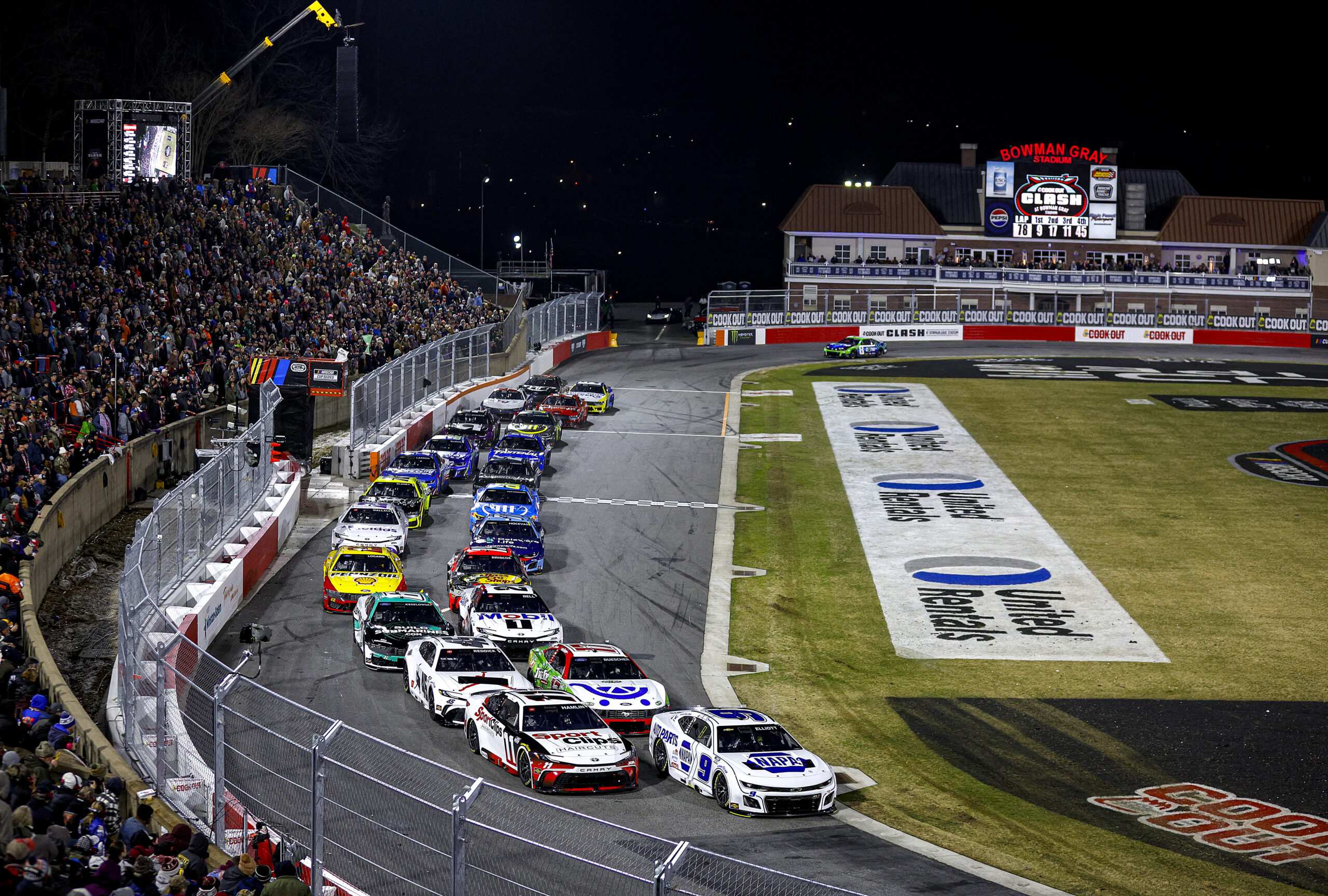 WINSTON SALEM, NORTH CAROLINA - FEBRUARY 02: Chase Elliott, driver of the #9 NAPA Auto Parts Chevrolet and Denny Hamlin, driver of the #11 Sport Clips Haircuts Toyota lead the field during the Cook Out Clash at Bowman Gray Stadium on February 02, 2025 in Winston Salem, North Carolina. (Photo by Sean Gardner/Getty Images)