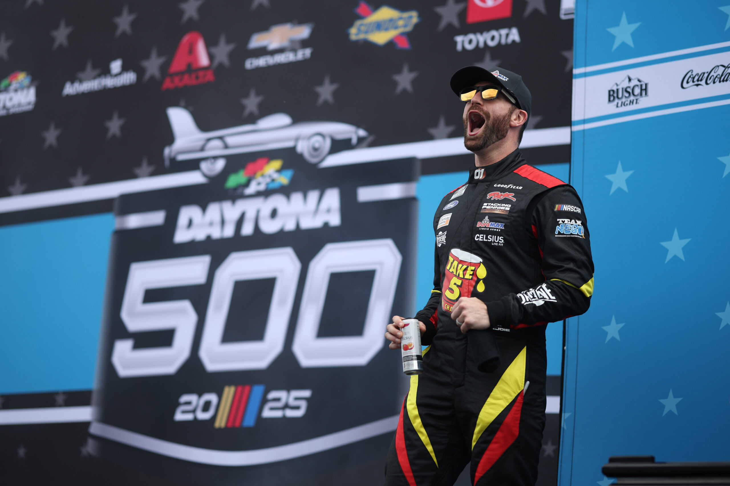 DAYTONA BEACH, FLORIDA - FEBRUARY 16: Corey LaJoie, driver of the #01 Take 5 Oil Change/DuraMax Ford walks onstage during driver intros prior to the NASCAR Cup Series Daytona 500 at Daytona International Speedway on February 16, 2025 in Daytona Beach, Florida. (Photo by James Gilbert/Getty Images)
