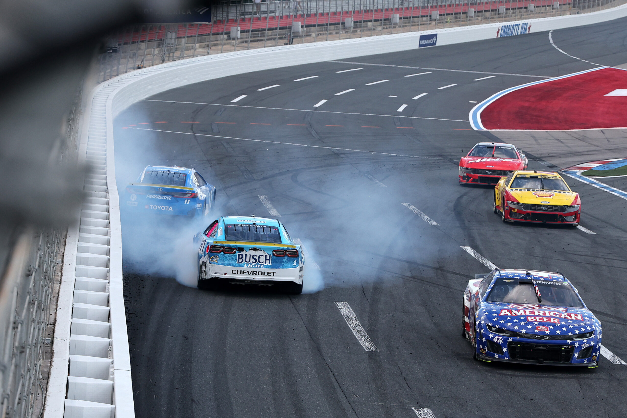 CONCORD, NORTH CAROLINA - OCTOBER 05: Ross Chastain, driver of the #1 Busch Light Chevrolet, and Denny Hamlin, driver of the #11 Progressive Toyota, spin after an on-track incident to finish the race in reverse to end the NASCAR Cup Series Bank of America ROVAL 400 at Charlotte Motor Speedway on October 05, 2025 in Concord, North Carolina. (Photo by David Jensen/Getty Images)