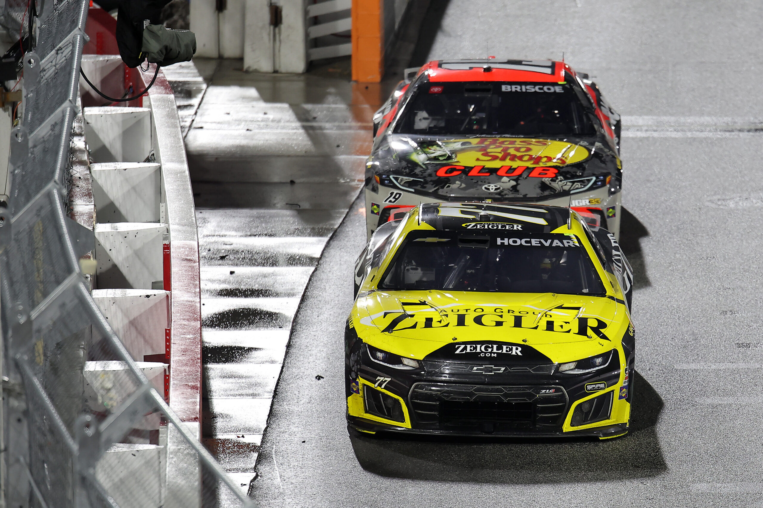 WINSTON SALEM, NORTH CAROLINA - FEBRUARY 04: Carson Hocevar, driver of the #77 Zeigler Auto Group Chevrolet, and Chase Briscoe, driver of the #19 Bass Pro Shops Toyota, race during the Cook Out Clash at Bowman Gray Stadium at Bowman Gray Stadium on February 04, 2026 in Winston Salem, North Carolina.