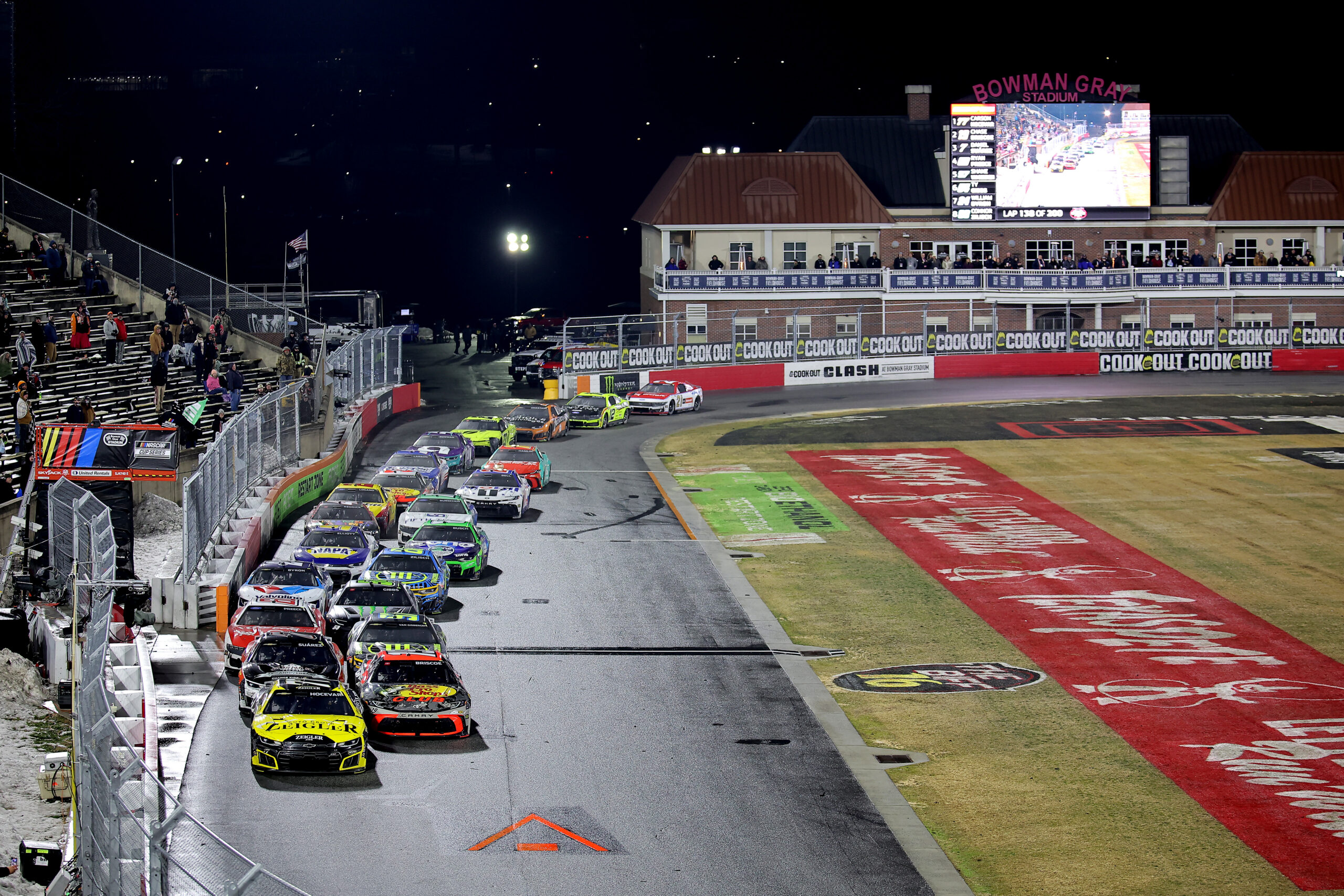 WINSTON SALEM, NORTH CAROLINA - FEBRUARY 04: Carson Hocevar, driver of the #77 Zeigler Auto Group Chevrolet, and Chase Briscoe, driver of the #19 Bass Pro Shops Toyota, lead the field during the Cook Out Clash at Bowman Gray Stadium at Bowman Gray Stadium on February 04, 2026 in Winston Salem, North Carolina. (Photo by Jonathan Bachman/Getty Images)