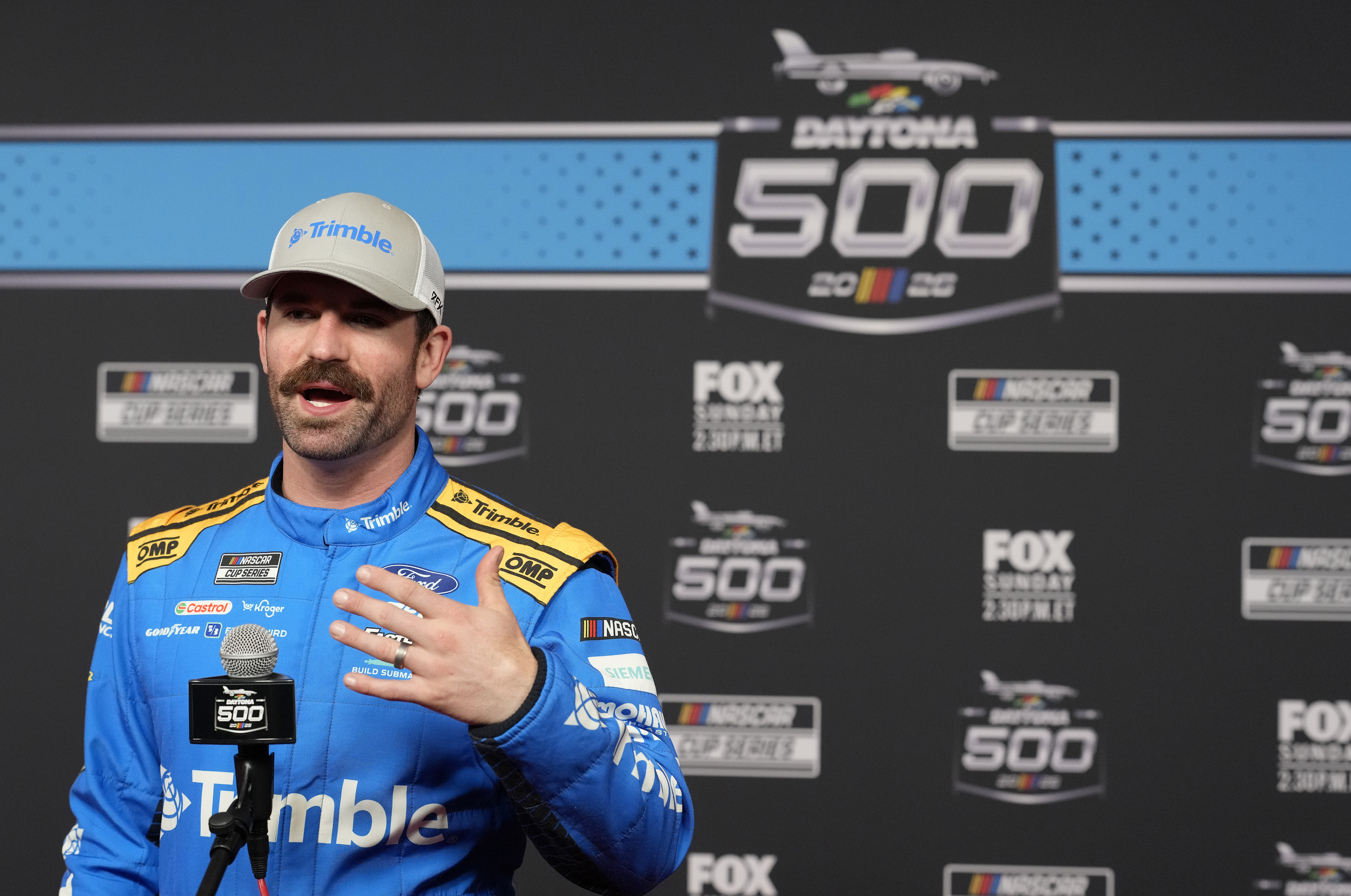 DAYTONA BEACH, FLORIDA - FEBRUARY 11: Corey LaJoie, driver of the #99 Trimble Ford, speaks to the media during Media Day for the NASCAR Cup Series Daytona 500 at Daytona International Speedway on February 11, 2026 in Daytona Beach, Florida. (Photo by Patrick McDermott/Getty Images)
