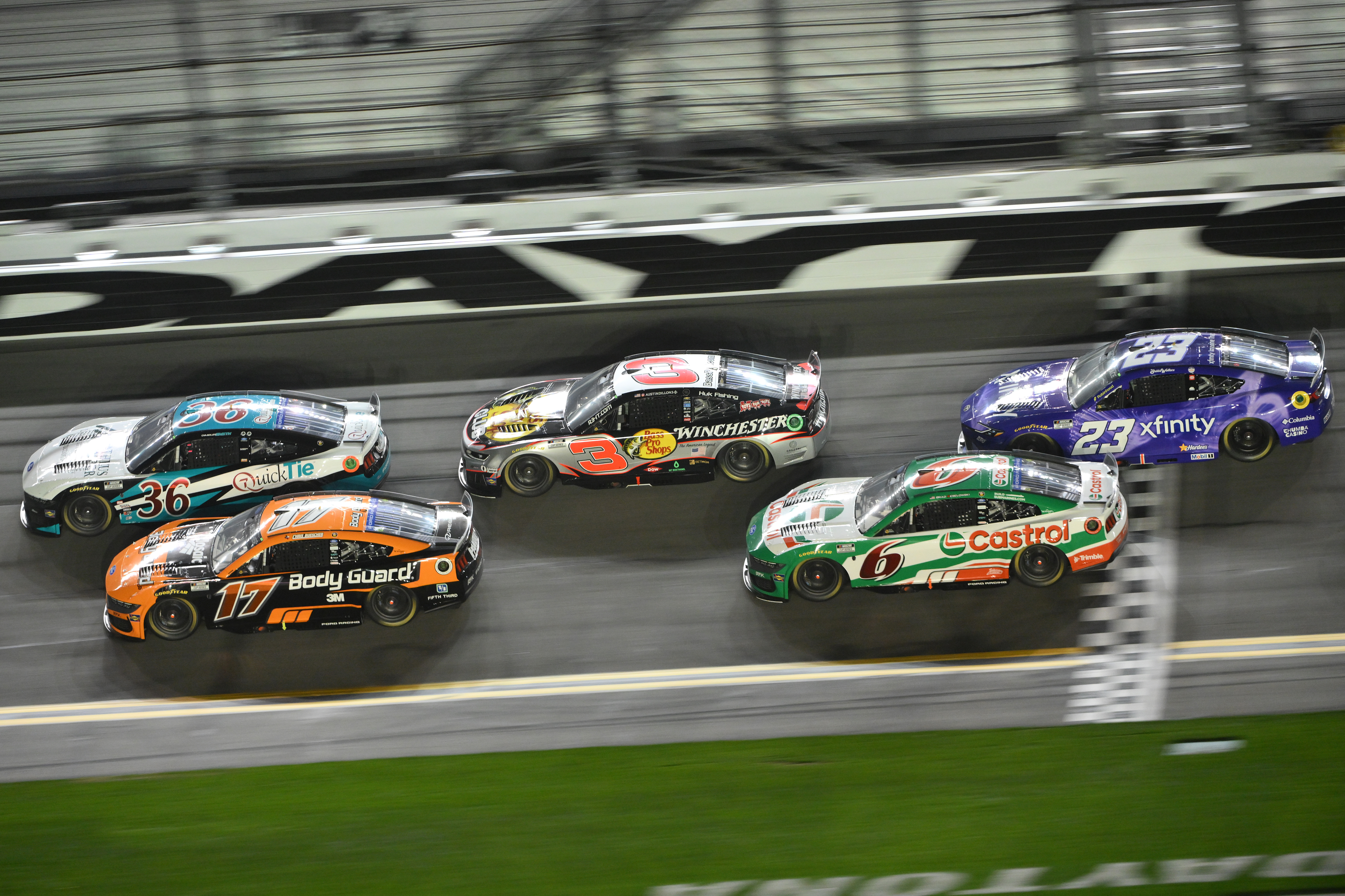 DAYTONA BEACH, FLORIDA - FEBRUARY 12: Chandler Smith, driver of the #36 Quick Tie/Matheus Lumber Ford, Chris Buescher, driver of the #17 Body Guard Ford, Austin Dillon, driver of the #3 Bass Pro Shops/Winchester Chevrolet, Brad Keselowski, driver of the #6 Castrol Ford, and Bubba Wallace, driver of the #23 Xfinity Toyota, race during Duel 1 for the NASCAR Cup Series Daytona 500 at Daytona at Daytona International Speedway on February 12, 2026 in Daytona Beach, Florida. (Photo by Jeff Curry/Getty Images)