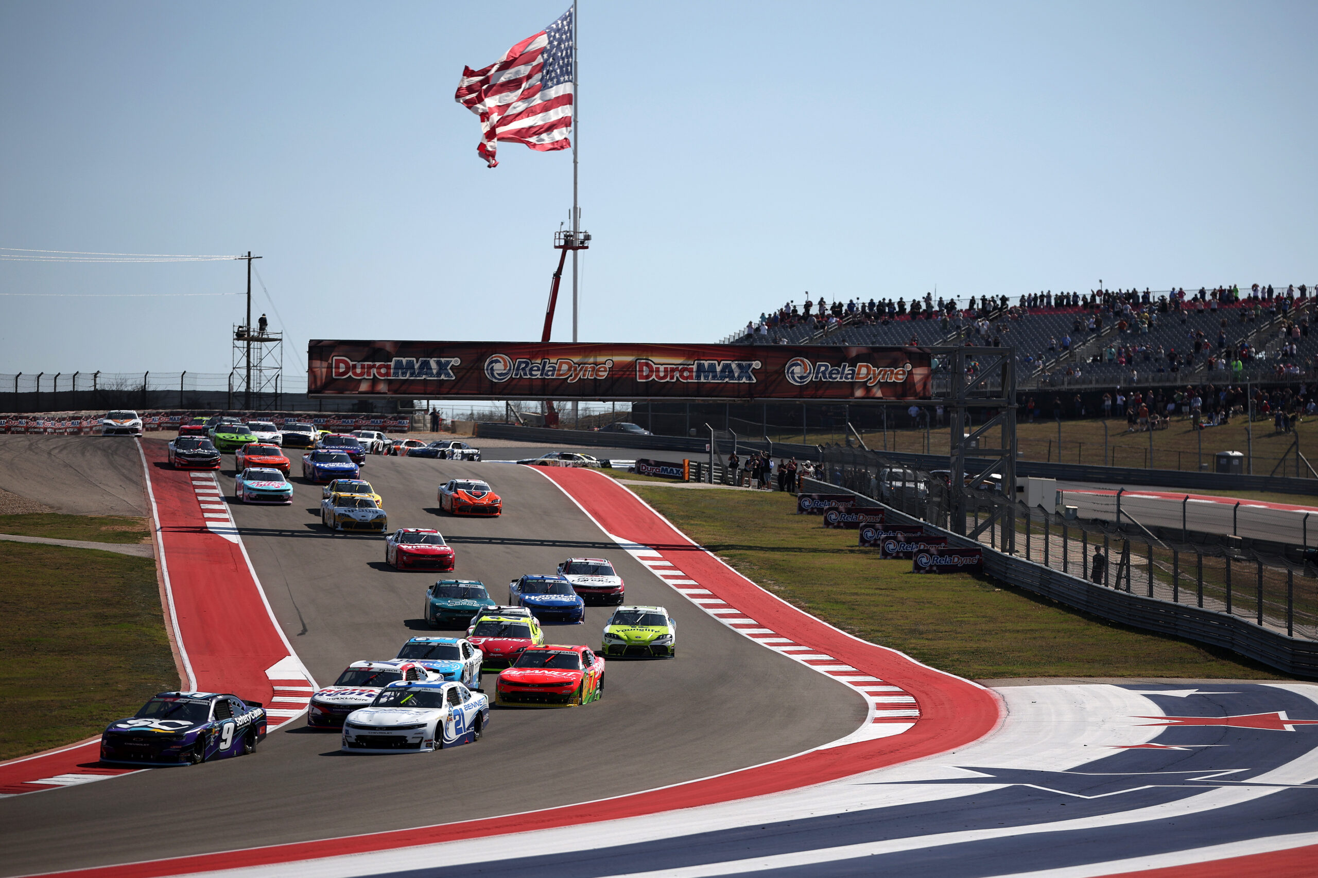 AUSTIN, TEXAS - FEBRUARY 28: Shane Van Gisbergen, driver of the #9 Safety Culture Chevrolet, and Austin Hill, driver of the #21 Bennett Transportation Chevrolet, lead the field during the NASCAR O'Reilly Auto Parts Series Focused Health 250 at Circuit of The Americas on February 28, 2026 in Austin, Texas.