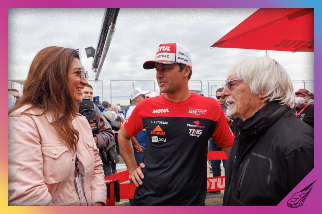 MOGI GUACU, BRAZIL - MAY 15: Driver Nelson Piquet Jr. speaks with Bernie Ecclestone and his wife Fabiana Flosi during a visit to the Velocitta racetrack for a Stock Car and Formula 4 race on May 15, 2022 in Mogi Guacu, Brazil. (Photo by Marcelo Machado de Melo/Getty Images)