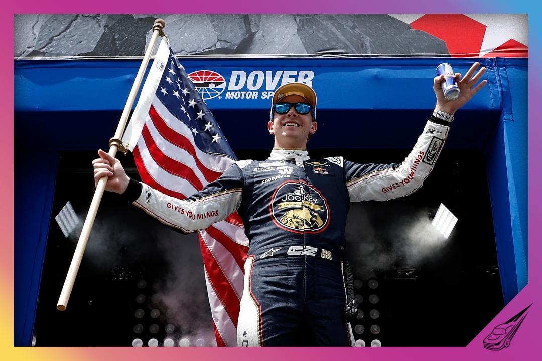 DOVER, DELAWARE - MAY 17: Connor Zilisch, driver of the #88 Jockey 150th Anniversary Chevrolet, carries an American flag onstage during driver intros prior to the NASCAR Cup Series All-Star Race at Dover Motor Speedway on May 17, 2026 in Dover, Delaware. (Photo by Sean Gardner/Getty Images)