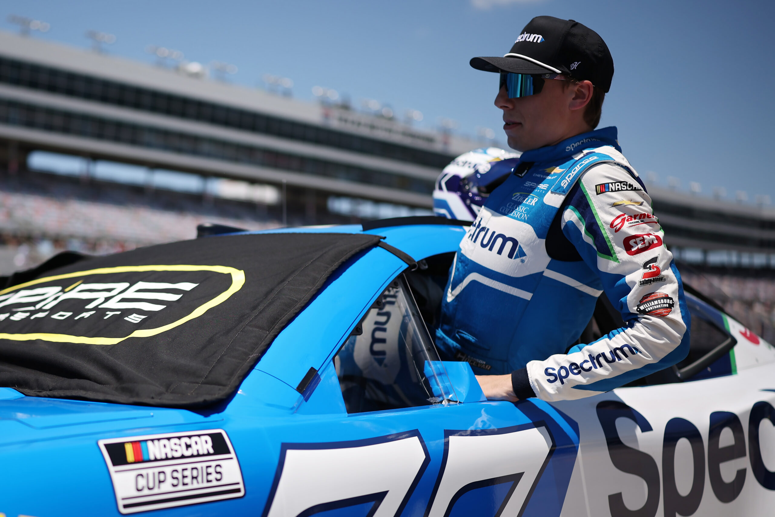 FORT WORTH, TEXAS - MAY 02: Carson Hocevar, driver of the #77 Spectrum Chevrolet, enters his car during qualifying for the NASCAR Cup Series Würth 400 presented by LIQUI MOLY at Texas Motor Speedway on May 02, 2026 in Fort Worth, Texas. (Photo by James Gilbert/Getty Images)