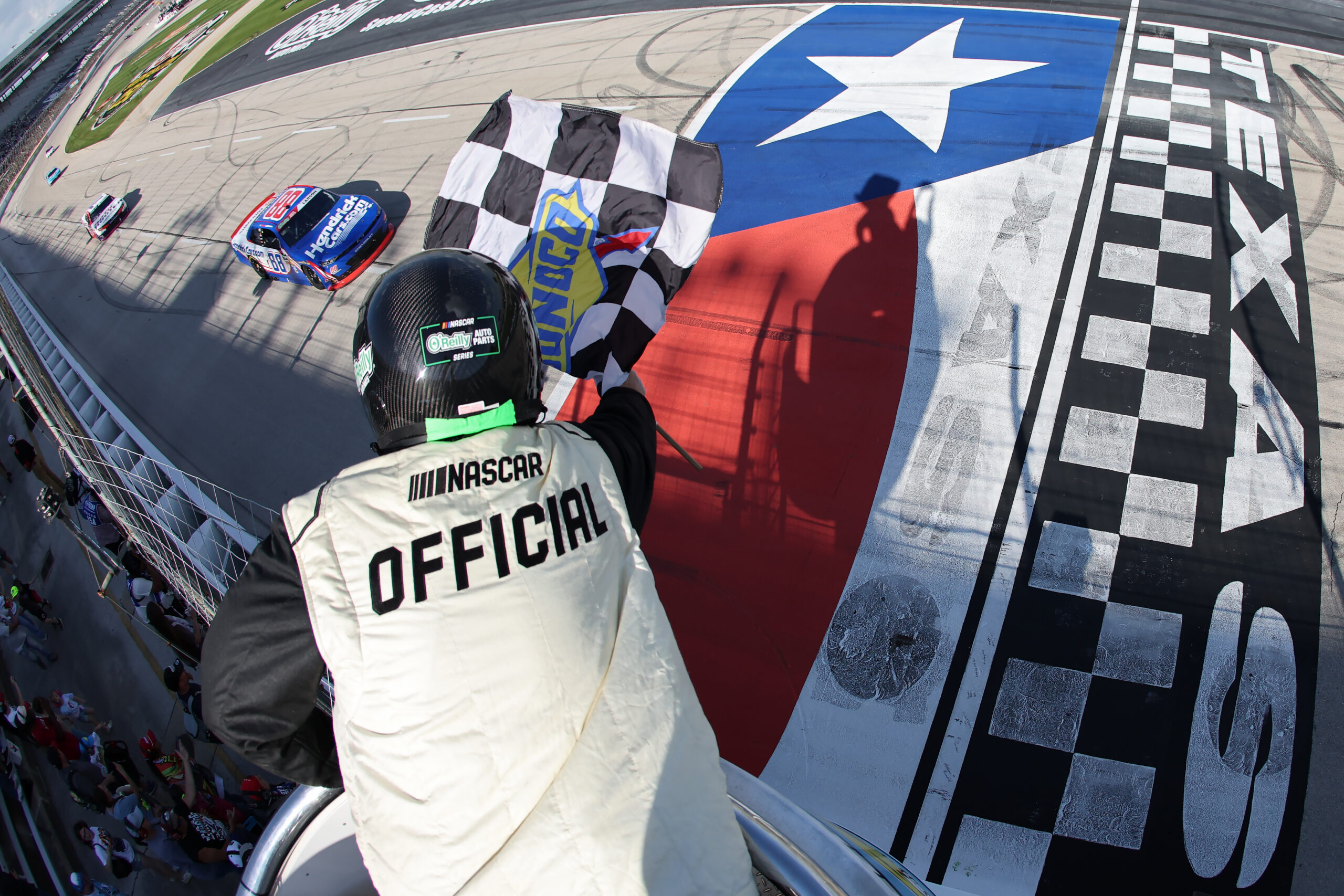 FORT WORTH, TEXAS - MAY 02: Kyle Larson, driver of the #88 HendrickCars.com Chevrolet, takes the checkered flag to win the NASCAR O'Reilly Auto Parts Series Andy's Frozen Custard 340 at Texas Motor Speedway on May 02, 2026 in Fort Worth, Texas.