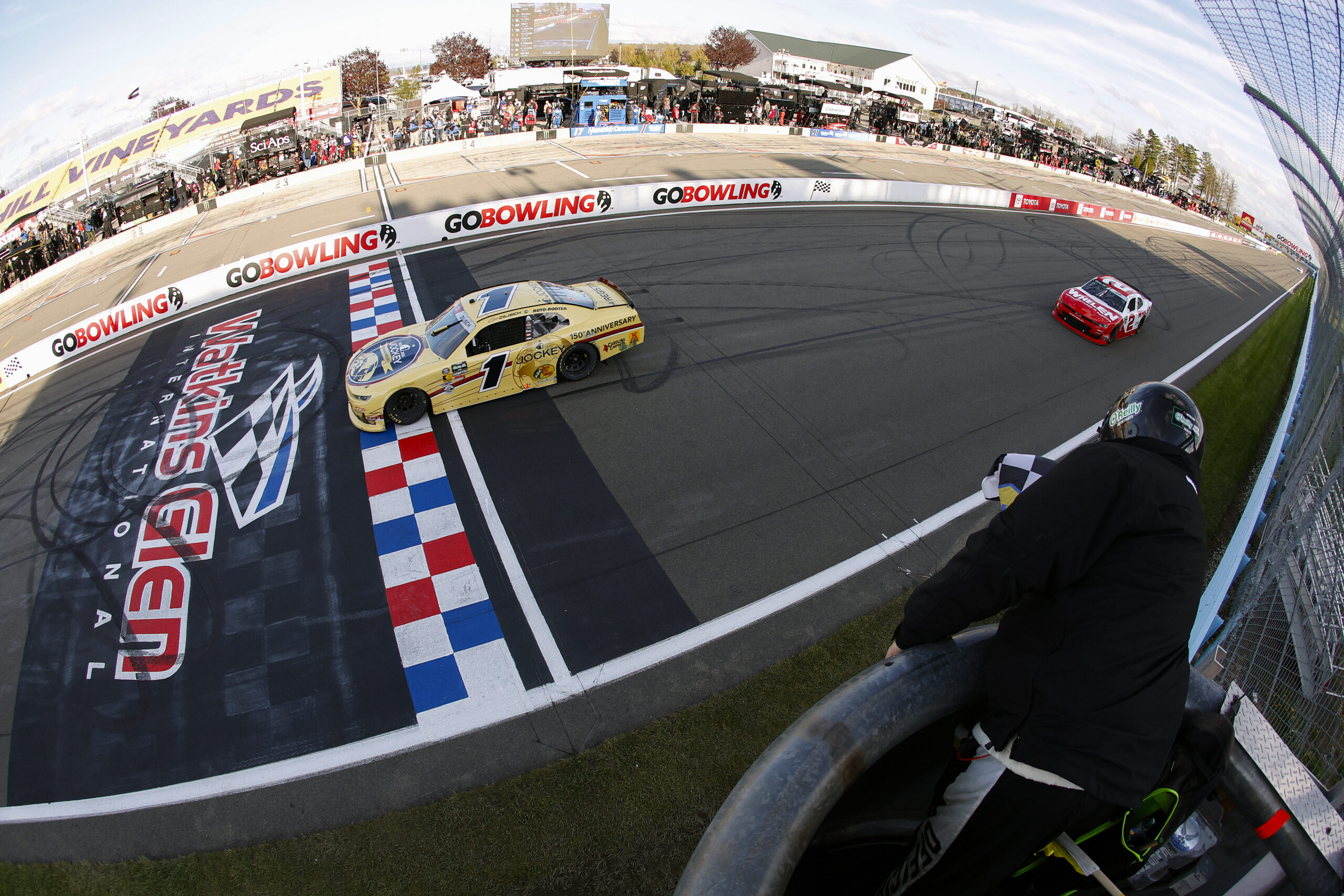 WATKINS GLEN, NEW YORK - MAY 09: Connor Zilisch, driver of the #1 Jockey 150 Years Chevrolet, takes the checkered flag ahead of Jesse Love, driver of the #2 Whelen Chevrolet, to win the NASCAR O'Reilly Auto Parts Series Mission 200 at The Glen at Watkins Glen International on May 09, 2026 in Watkins Glen, New York.