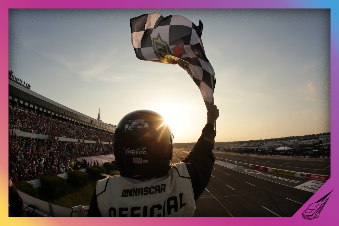 LONG POND, PENNSYLVANIA - JUNE 22: A NASCAR Official waves the checkered flag during the NASCAR Cup Series The Great American Getaway 400 at Pocono Raceway on June 22, 2025 in Long Pond, Pennsylvania. (Photo by Jonathan Bachman/Getty Images)