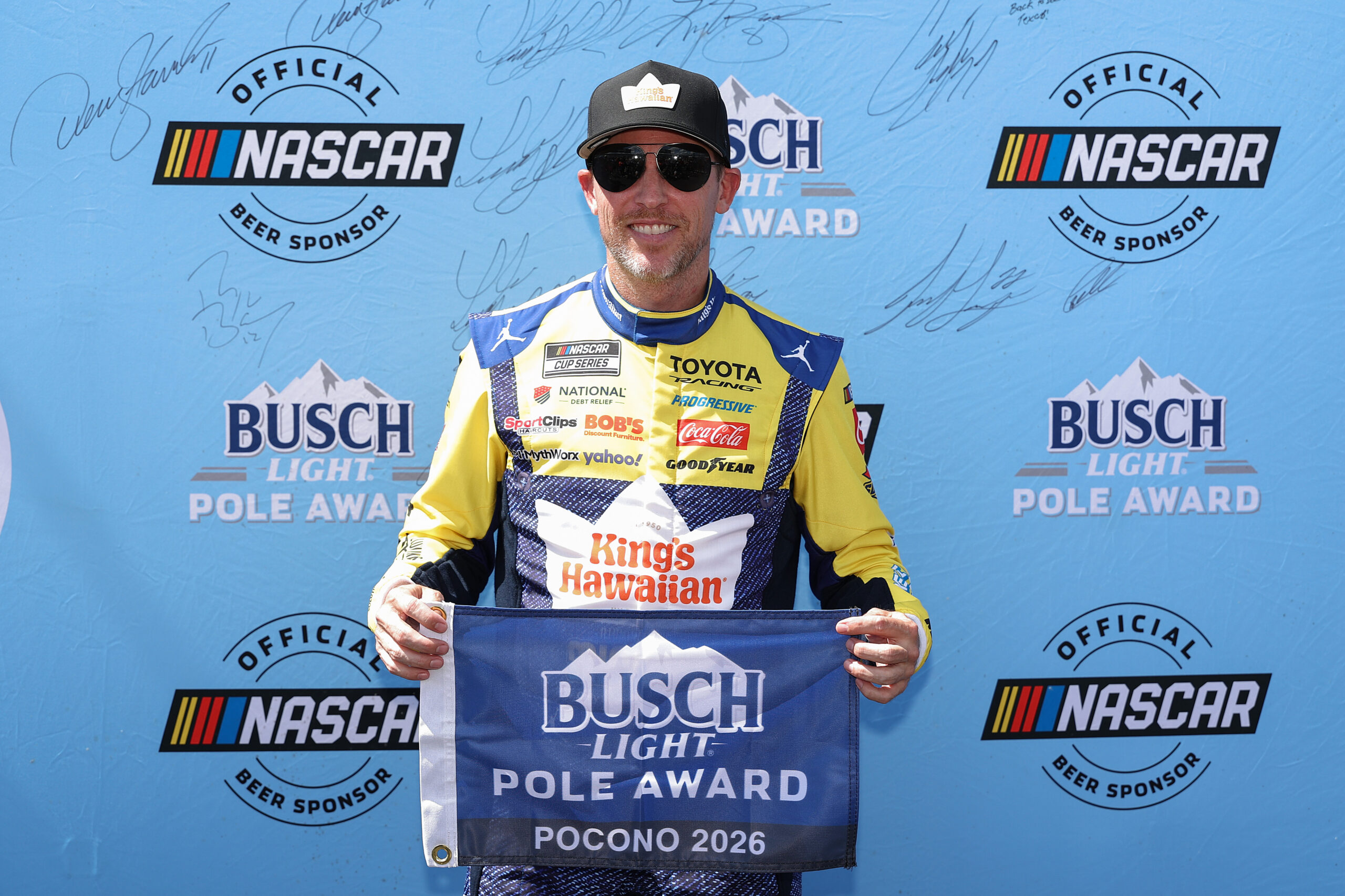 LONG POND, PENNSYLVANIA - JUNE 13: Denny Hamlin, driver of the #11 King's Hawaiian Shake 'Em Bites Toyota, poses for photos after winning the pole award during qualifying for the NASCAR Cup Series Great American Getaway 400 presented by VISITPA at Pocono Raceway on June 13, 2026 in Long Pond, Pennsylvania.