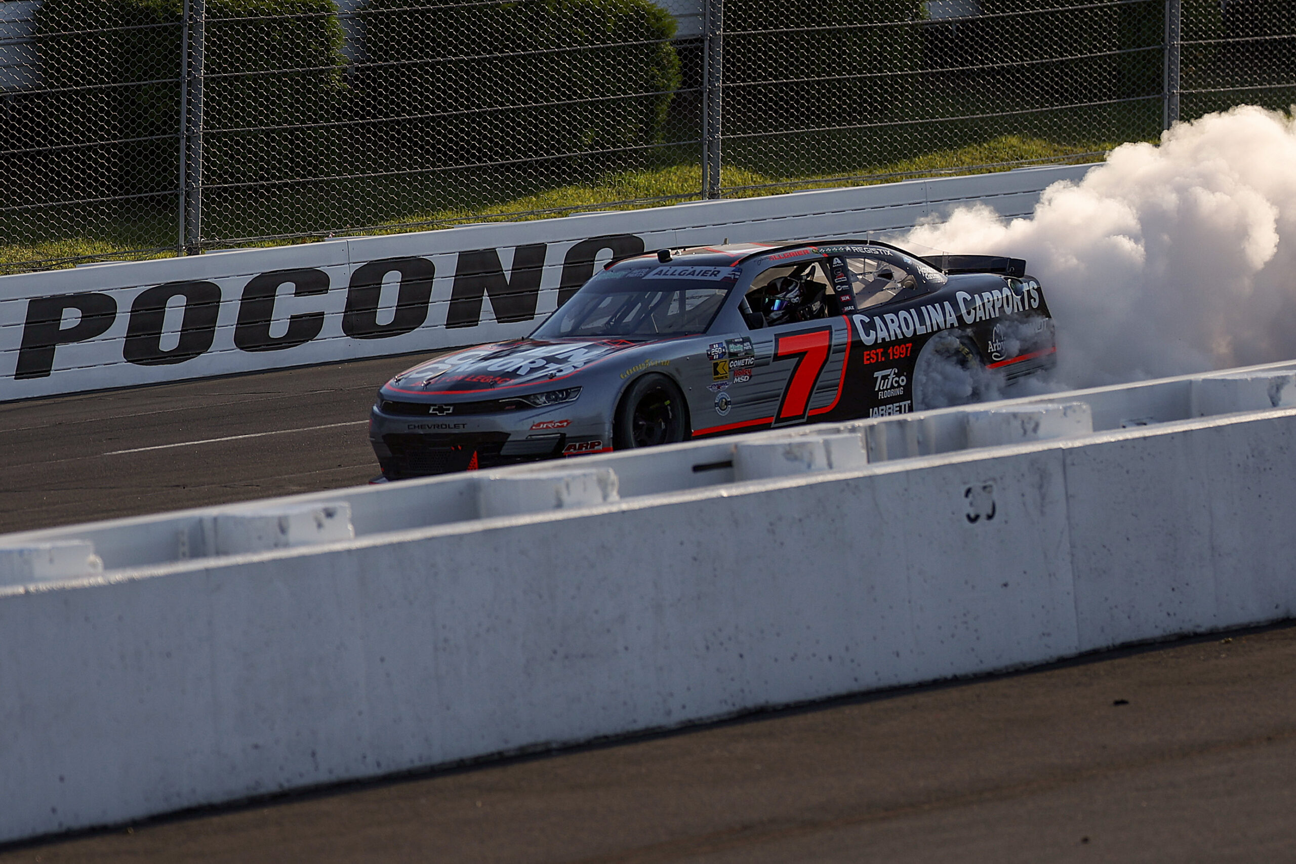 celebrates with a burnout after winning the NASCAR O'Reilly Auto Parts Series MillerTech Battery 250 presented by KOA at Pocono Raceway on June 13, 2026 in Long Pond, Pennsylvania.