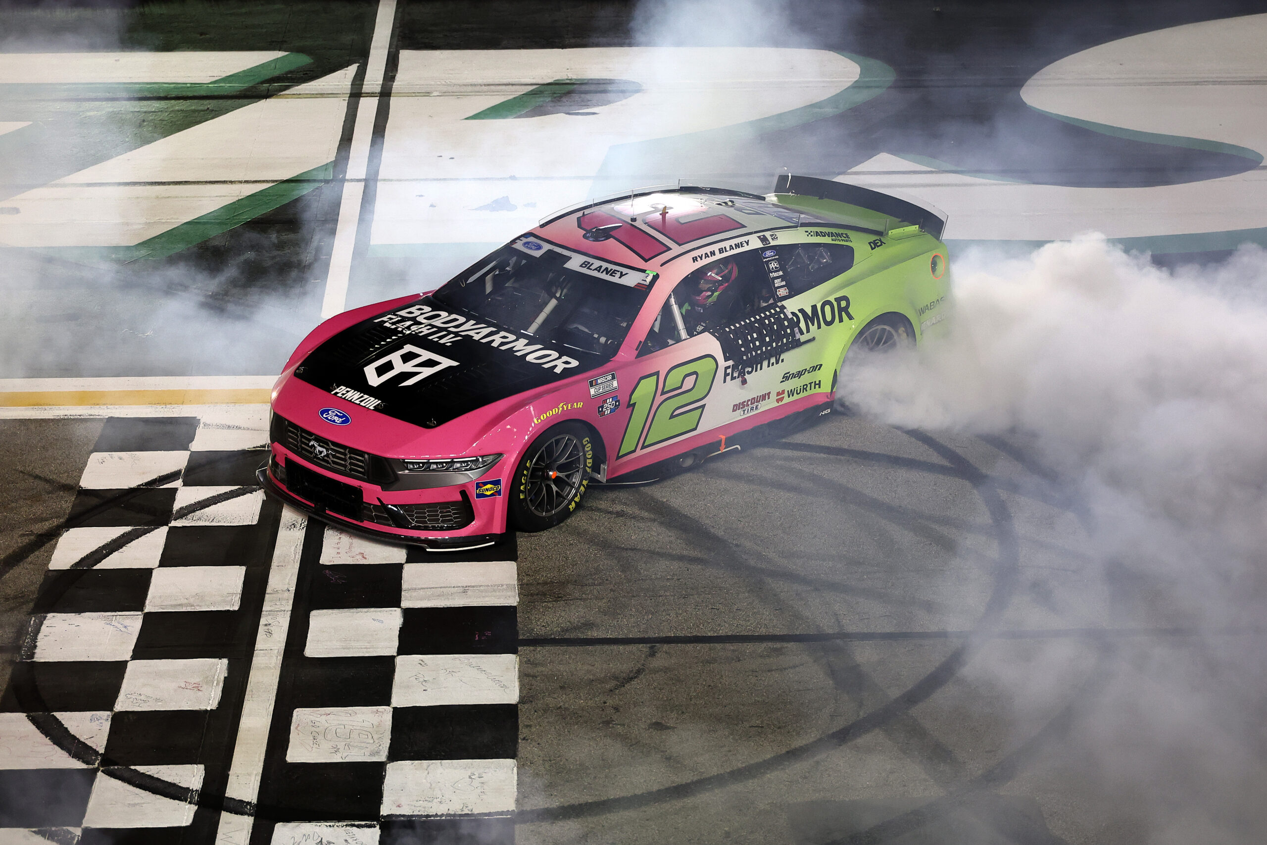 HAMPTON, GEORGIA - JULY 12: Ryan Blaney, driver of the #12 BODYARMOR FLASH I.V. Ford, celebrates with a burnout after winning the NASCAR Cup Series Quaker State 400 Available at Walmart at EchoPark Speedway on July 12, 2026 in Hampton, Georgia. (Photo by Meg Oliphant/Getty Images)