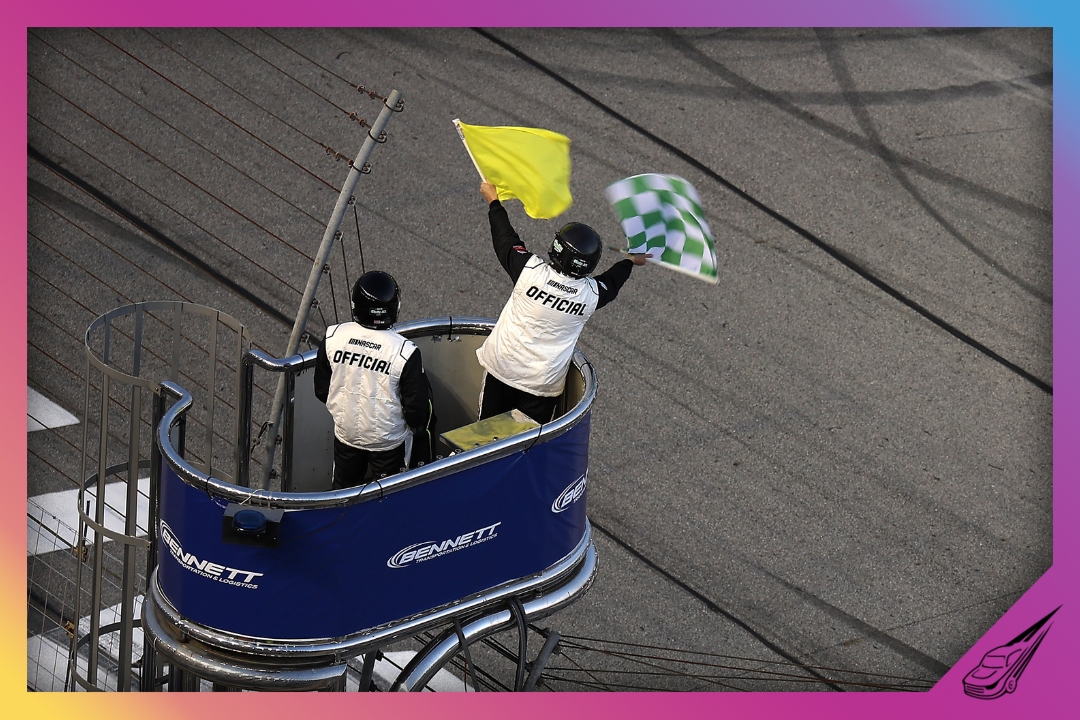 HAMPTON, GEORGIA - FEBRUARY 21: A NASCAR Official waves the caution and green-checkered flag to end stage two during the NASCAR O'Reilly Auto Parts Series Bennett Transportation & Logistics 250 at Echo Park Speedway on February 21, 2026 in Hampton, Georgia. (Photo by Jonathan Bachman/Getty Images)