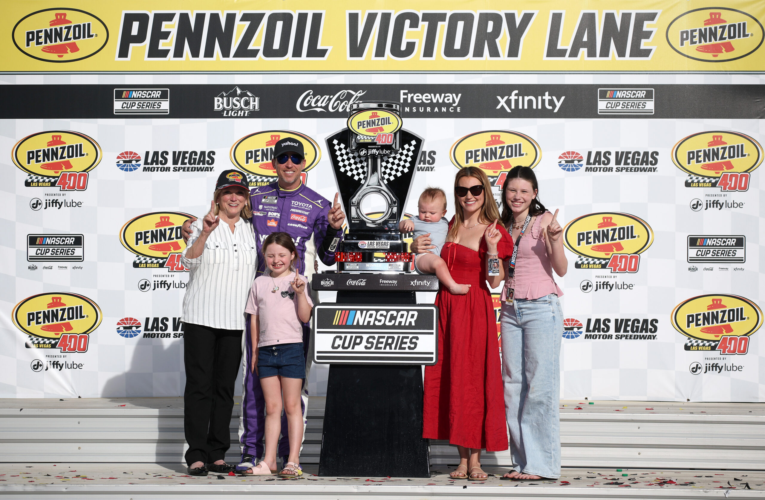 LAS VEGAS, NEVADA - MARCH 15: Denny Hamlin, driver of the #11 Yahoo! Toyota, celebrates celebrates with his mother, Mary Lou Hamlin (L) Jordan Fish daughters, Taylor Hamlin (R) Molly Hamlin and son Jameson Hamlin in victory lane after winning the NASCAR Cup Series Pennzoil 400 presented by Jiffy Lube at Las Vegas Motor Speedway on March 15, 2026 in Las Vegas, Nevada. (Photo by Chris Graythen/Getty Images)